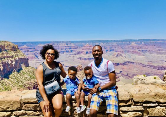 Family Sitting at Grand Canyon