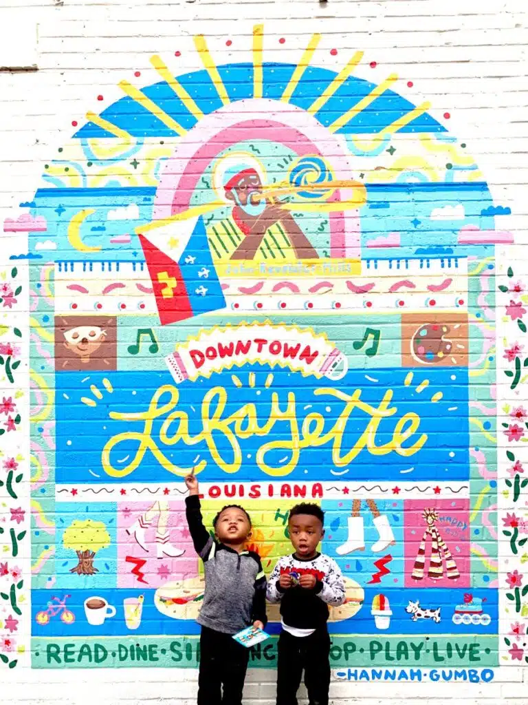 My boys in front of the Downtown Lafayette sign.