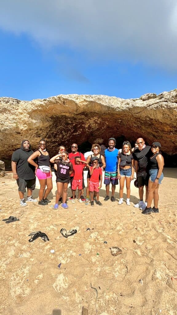 My family of 12 standing in front of the natural bridge in Aruba