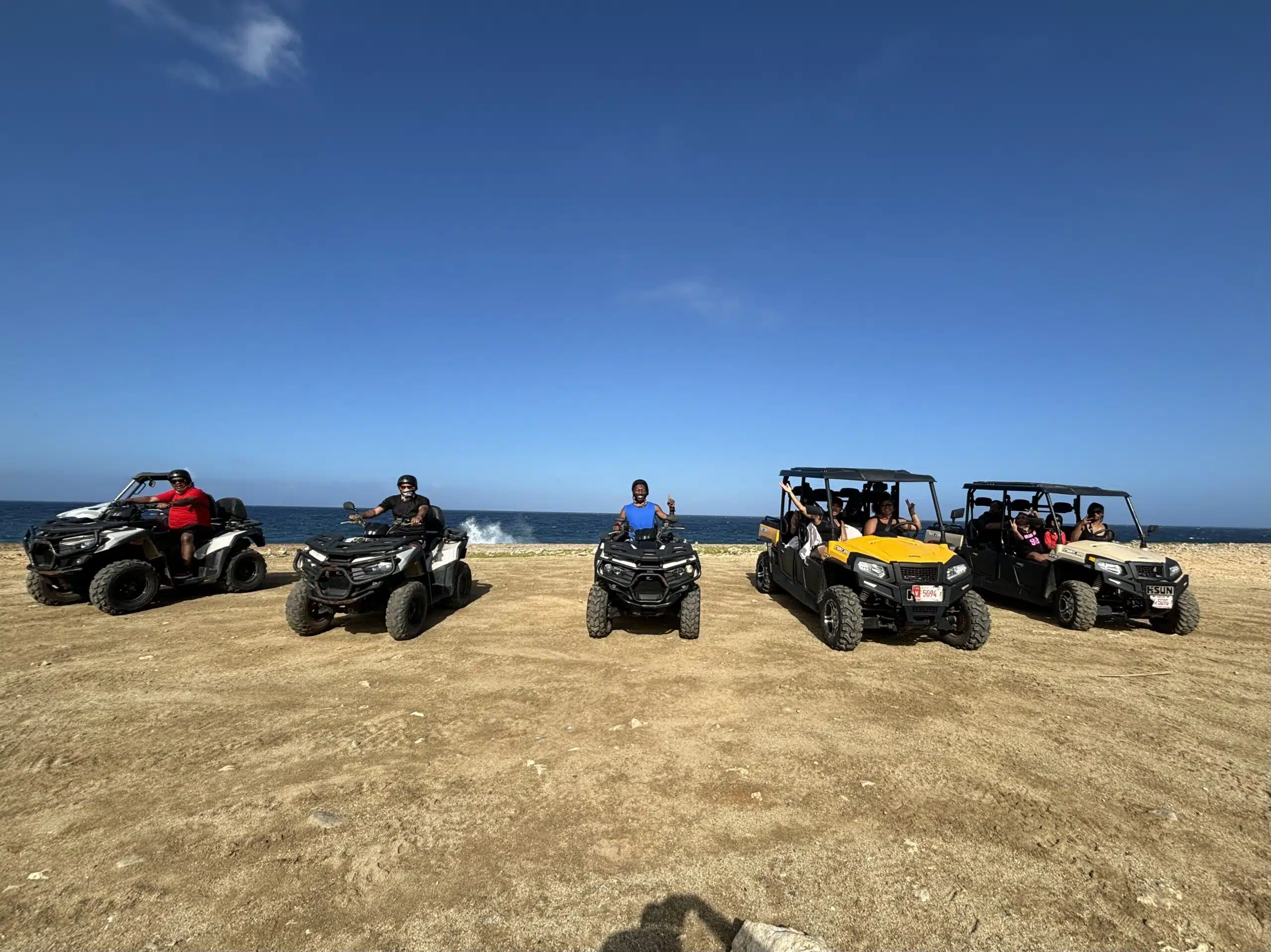 Marquita’s family and others lined up in ATVs and UTVs during the Ultimate Island Jeep Safari tour in Aruba. The rugged coastal backdrop and open blue sky highlight a thrilling off-road adventure beyond the best beaches in Aruba.