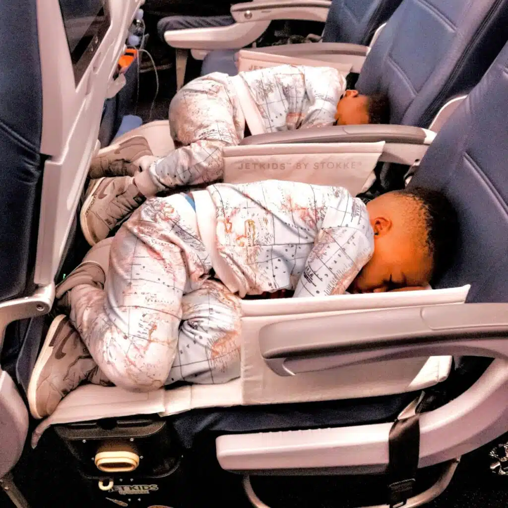 My boys sleeping soundly on an airplane using their JetKids BedBoxes.