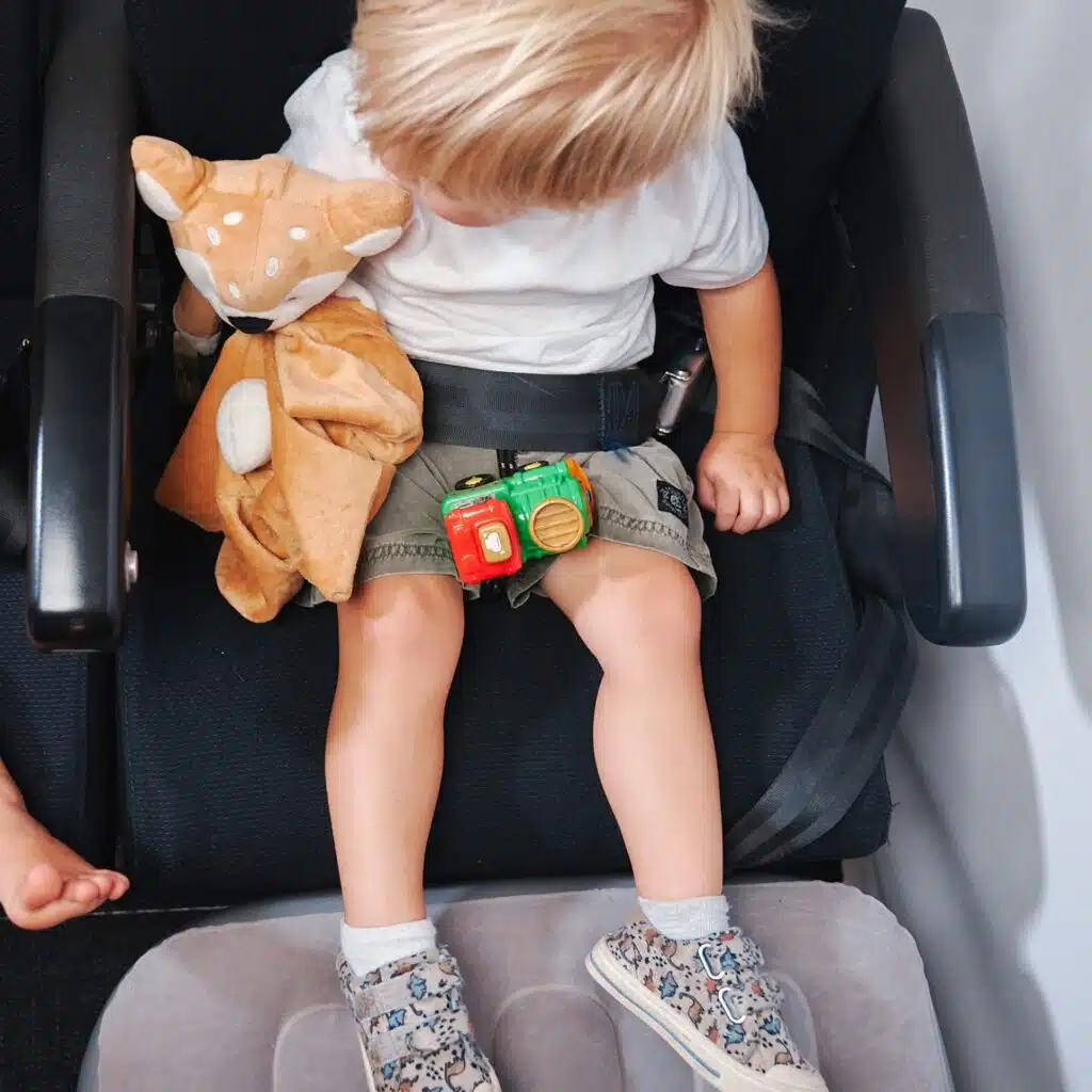 Toddler relaxing on his Kooshy Kids Inflatable Toddler Airplane Bed.