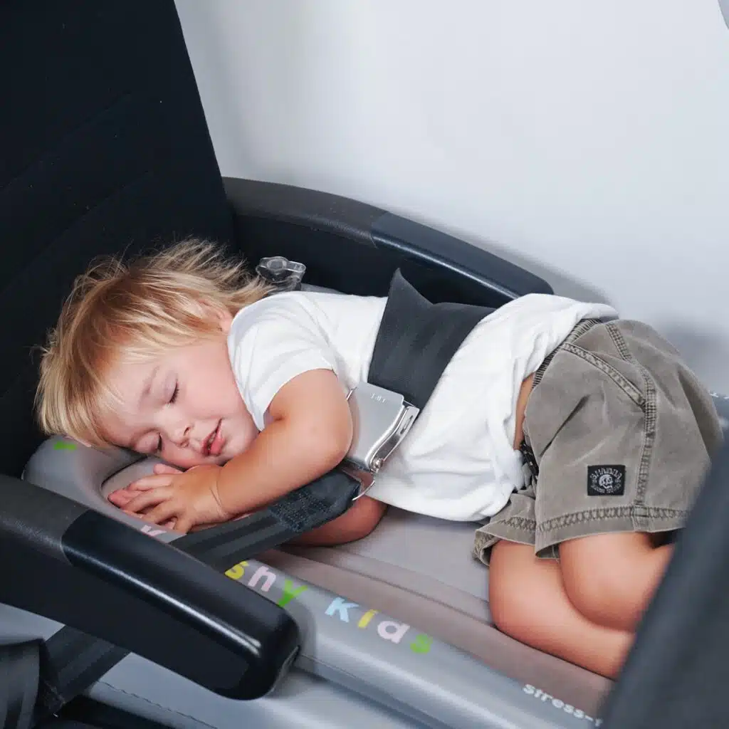 Toddler sleeping on Kooshy Kids Mushroom-Shaped Airplane Bed – one of the best toddler airplane beds.