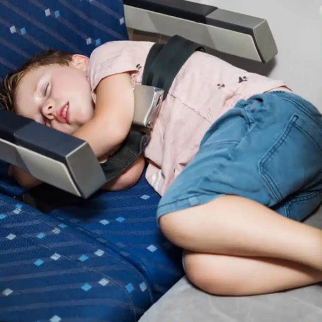 Toddler sleeping soundly on one of the best toddler airplane beds on the market.