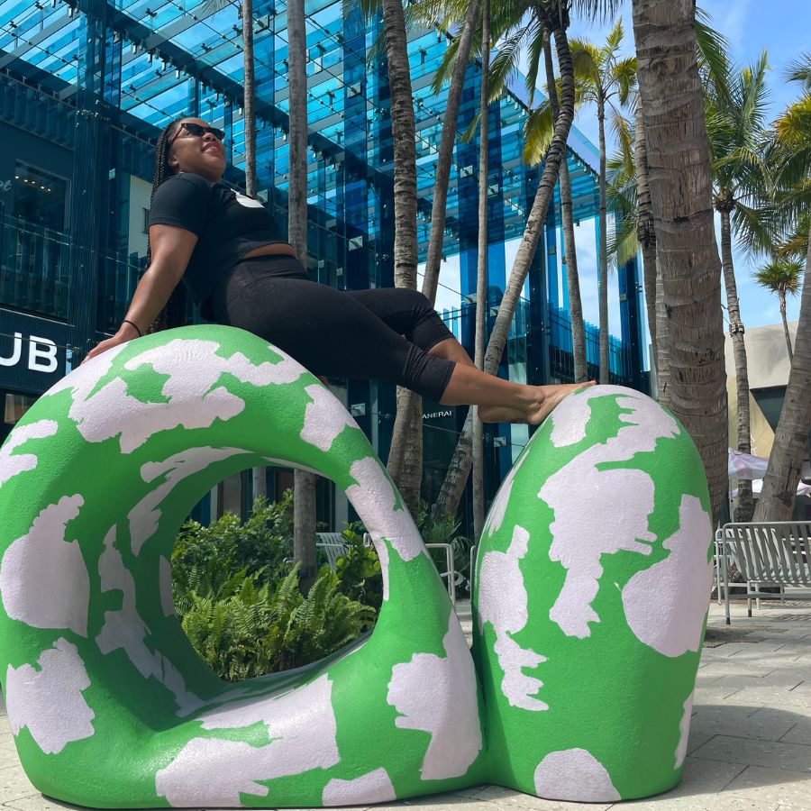 Me posting on a sculpture in the Miami Design District. 