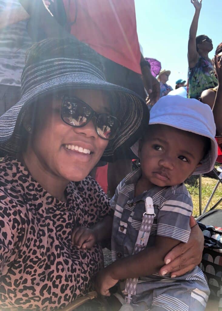 Me and my son in our hats during a sunny day at Jazz Fest in New Orleans.