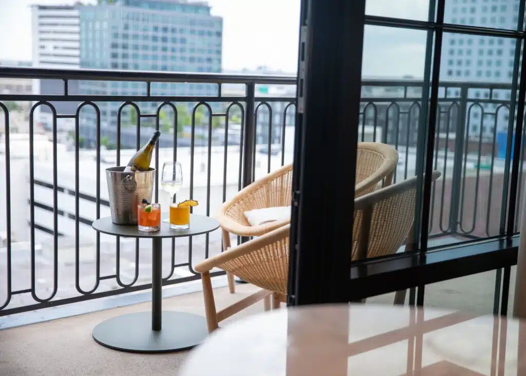 View of the balcony with drinks on the table at Virgin Hotels