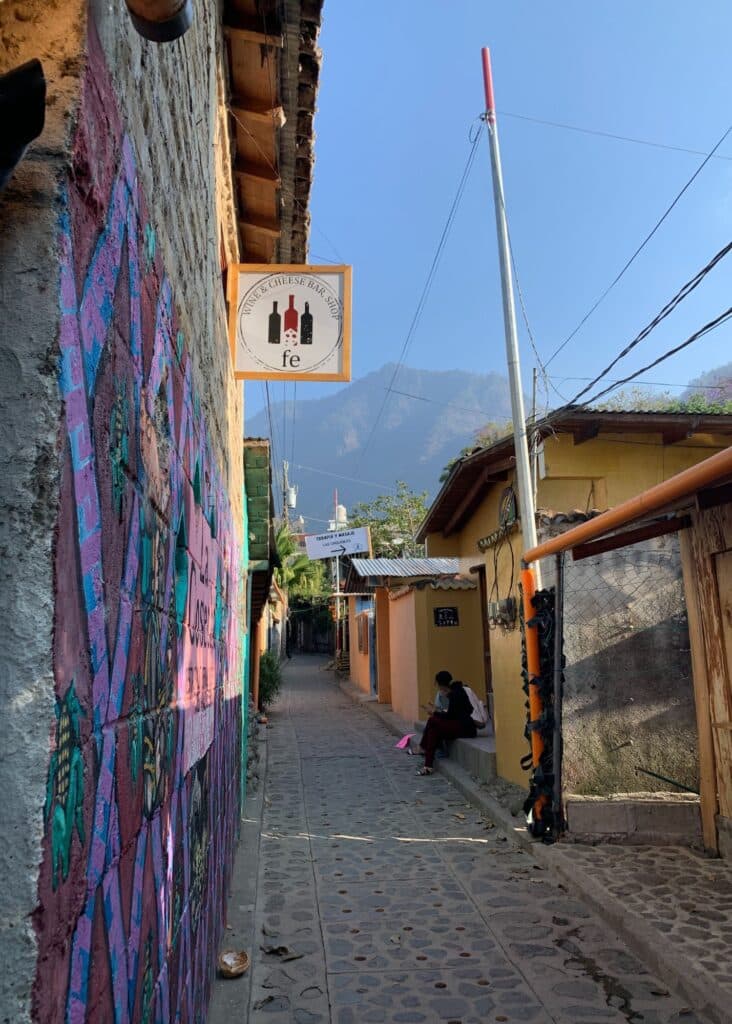 A charming street in San Marcos La Laguna in Lake Atitlan with mountain views in the backdrop. 