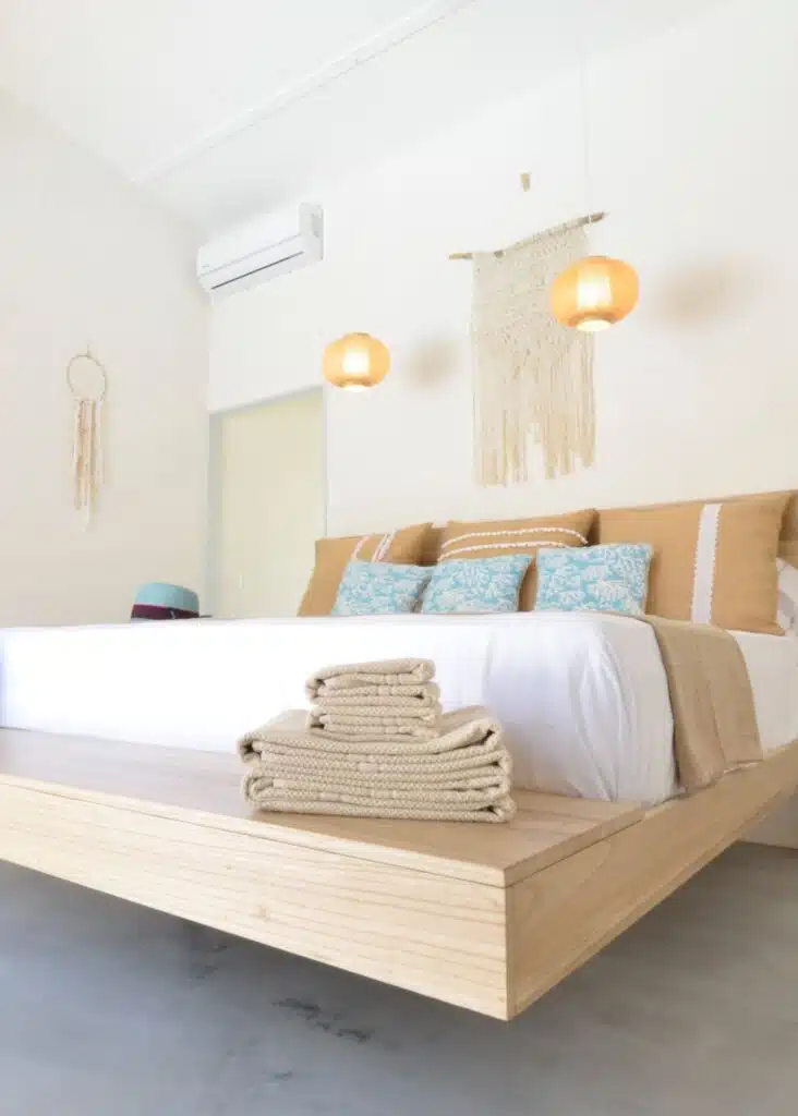 A modernly-decorated bed in one of the rooms at Boho Tamarindo Hotel in Costa Rica.