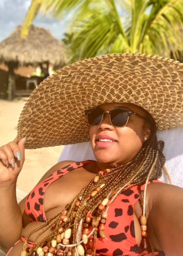 Chilling at the beach with my hat to cover from the sun. A hat is essential if you are wondering what to wear in Jamaica