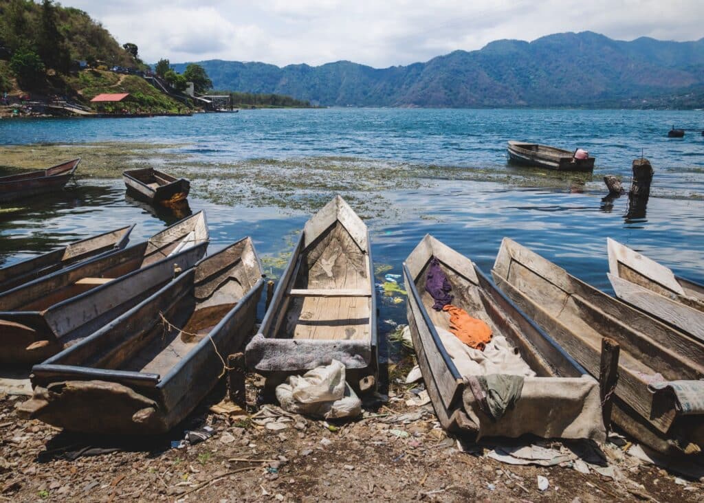 Canoes sitting on the shoreline of Lake Atitlan in quaint village of Santiago Atitlan