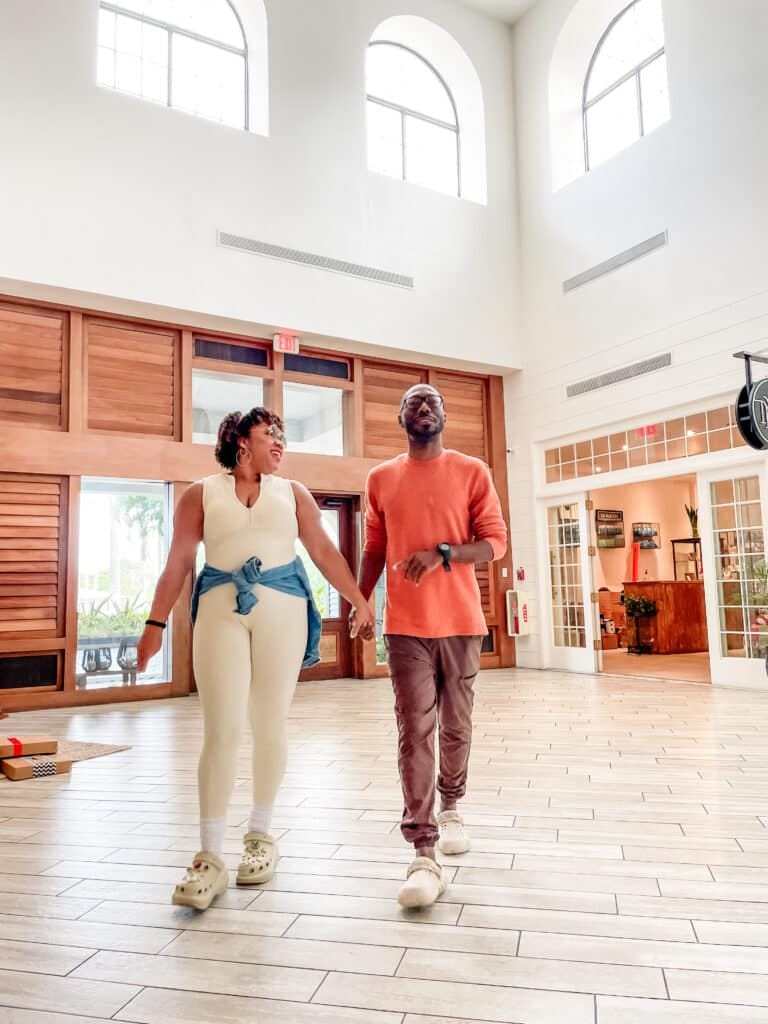 Arriving to the hotel with a cream athleisure jumpsuit with a oversized jean jacket around my waist. The cream Mega Crush Clogs makes it the perfect outfit to wear in Hawaii.