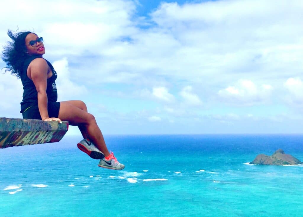 Posing on the edge of a cliff at Lanikai Pillbox in Ohau, Hawaii wearing comfy athletic wear.