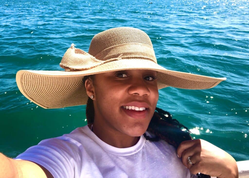 Me in my favorite sunhat by the water. A sunhat is a must-have when packing for Hawaii.