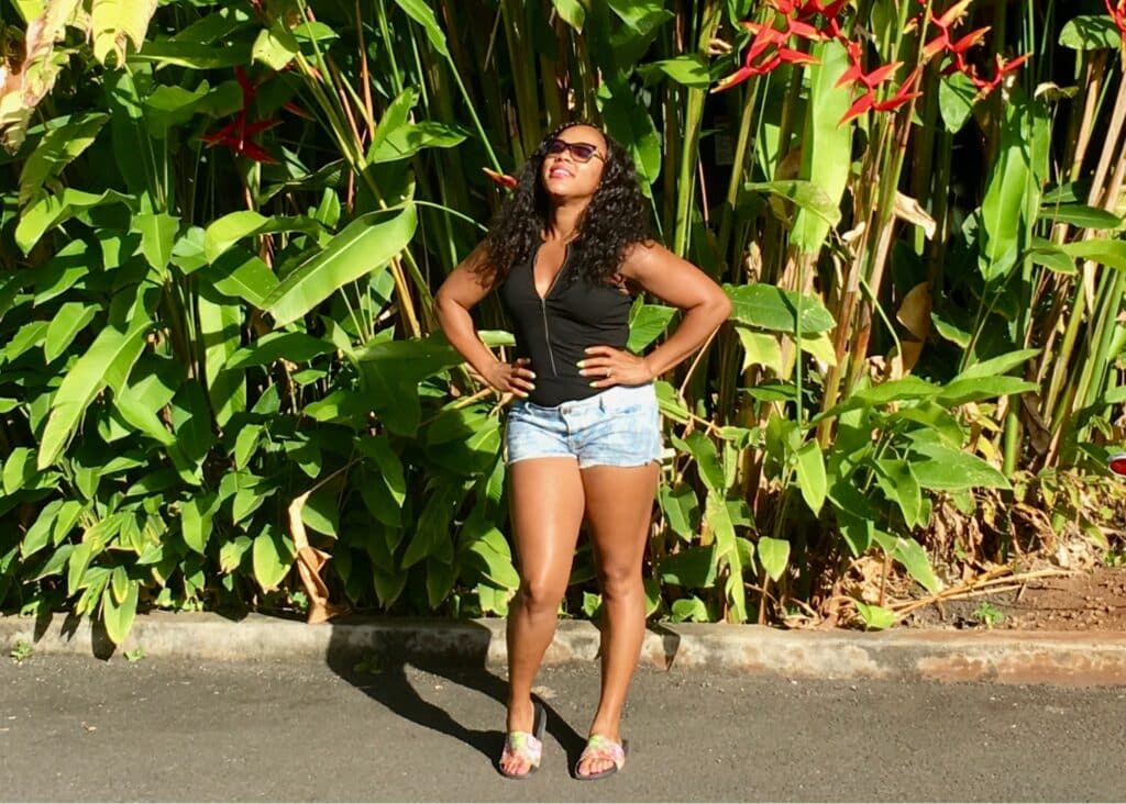 Me wearing a black top and jean shorts in Hawaii. Shorts are a must-pack when it comes to what to wear in Hawaii.