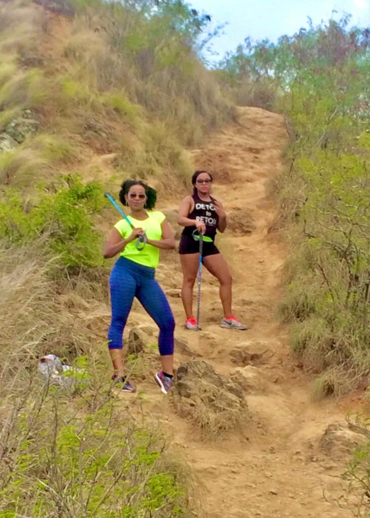 My friend and I with our hiking poles in Hawaii. If you're wondering what to wear in Hawaii while hiking, the answer is comfortable clothes and shoes.