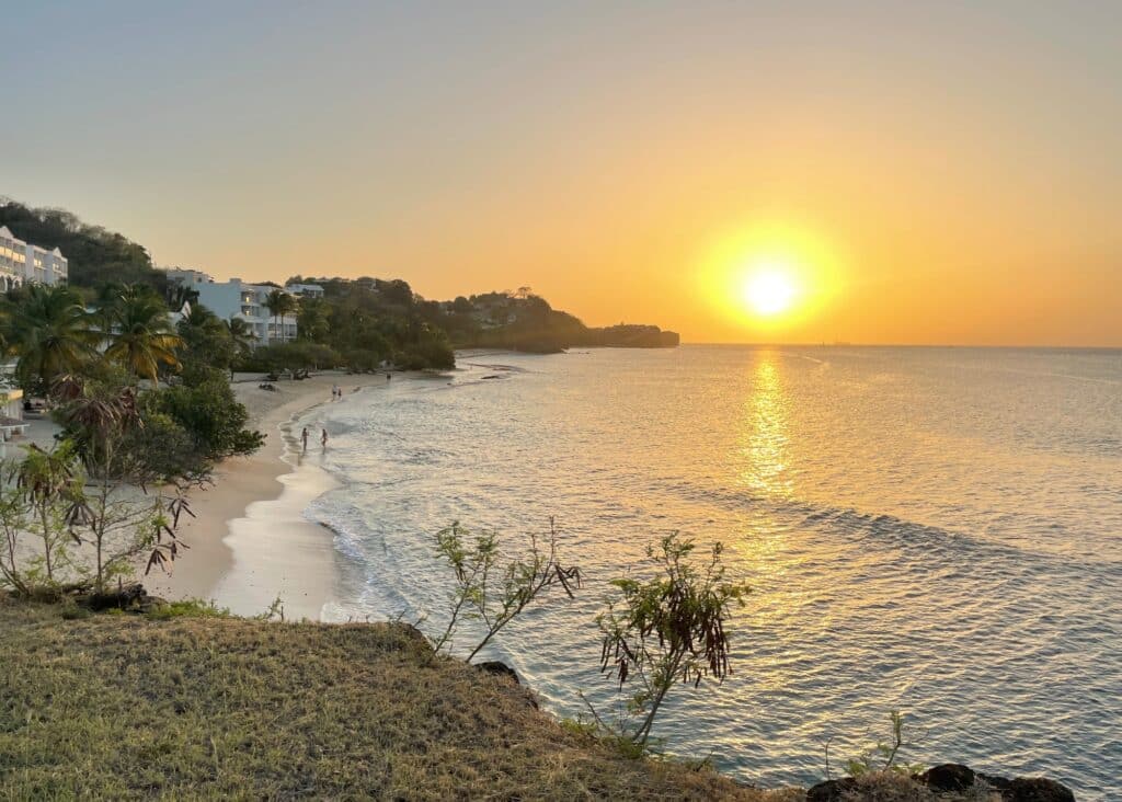 The sun setting in the horizon of the beach in Grenada.