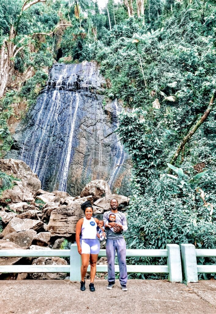 My husband and I holding our twin 5 month olds in front of La Coca Falls in El Yunque Rainforest, Puerto Rico