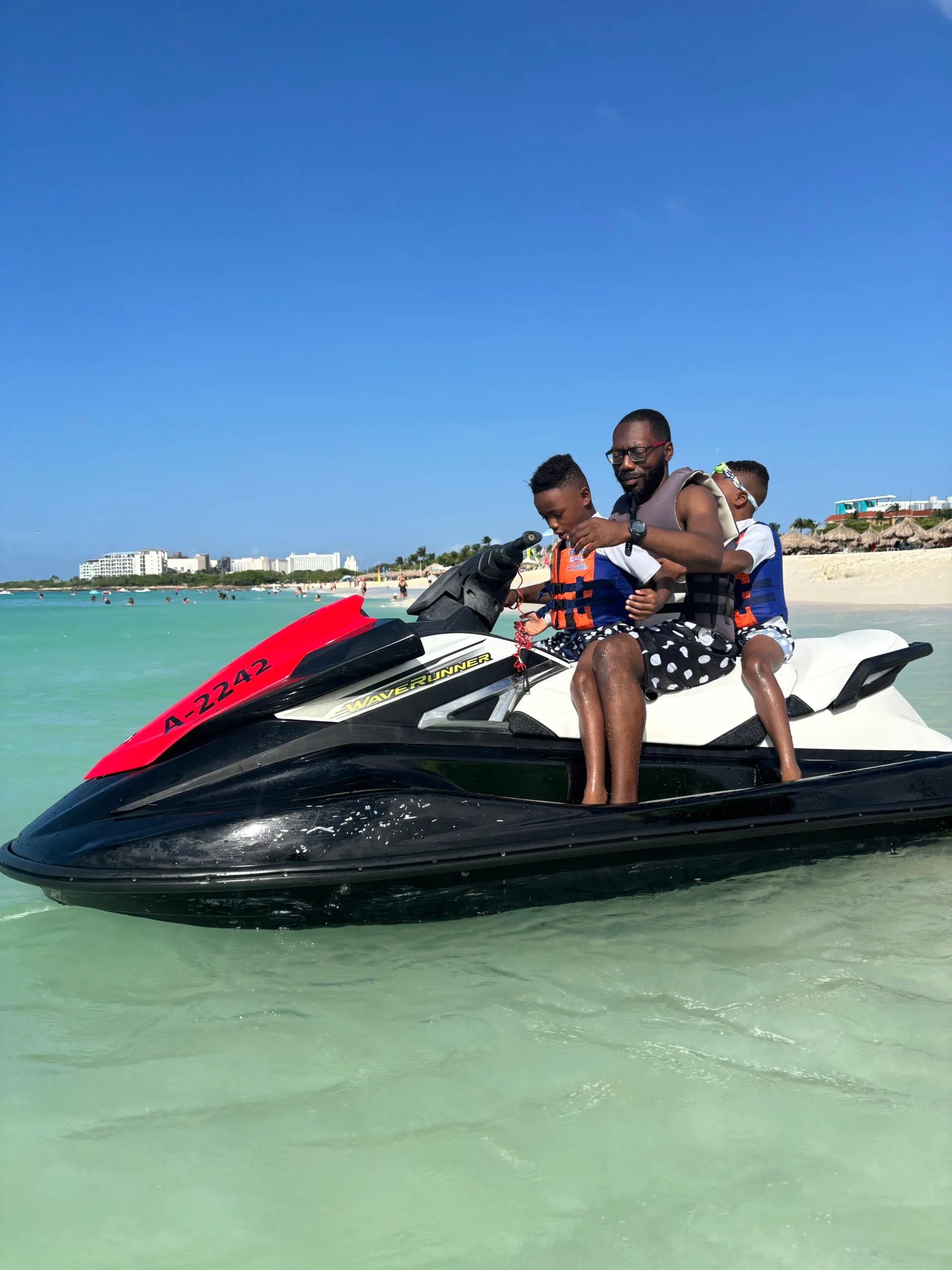 My husband and twin 6 year old boys on a jet ski at Eagle Beach in Aruba