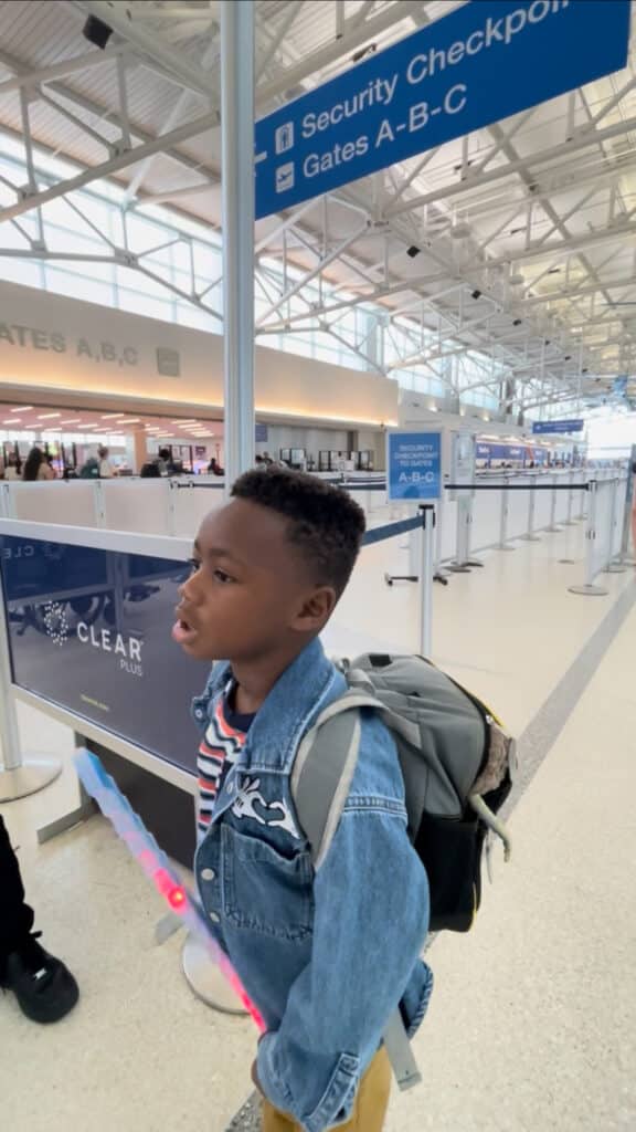Boy standing in front of CLEAR at airport security