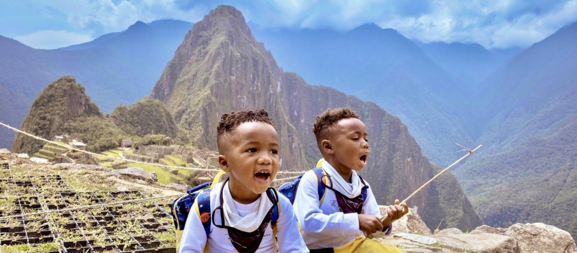 Twin toddler boys posing in front of the Machu Picchu