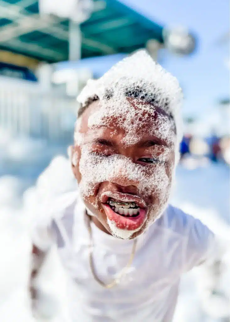 One of Marquita’s sons grins at the camera with his face and hair completely covered in bubbles during the foam party at The Hangout in Gulf Shores Alabama.